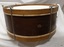 Drum is wider at the top due to the tension rods' handles. 