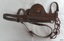 Horse winkers have an oval metal badge on the outside, left and right
