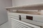 Top has wide drilled holes. The angled roof is slightly raised above the top.