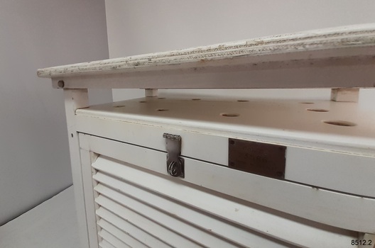 Top has wide drilled holes. The angled roof is slightly raised above the top.