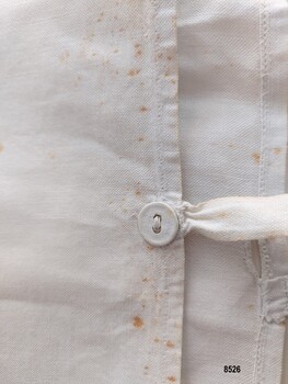 Close up view of the sham's button, buttonhole and tie.
