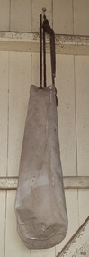 Beige long canvas bag with round base and drawerstring closure