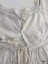 Neckline and back opening of a child's white dress