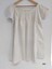 Back view of white, cotton chemise with pintucks and broderie anglaise on sleeves and neckline