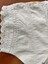 View of stitching, broderie anglaise lace trim and pintucks on sleeve