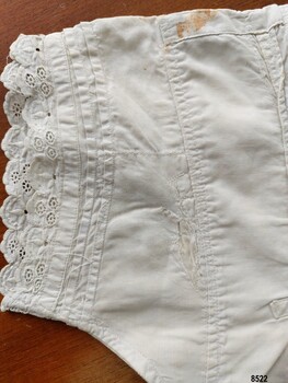 View of stitching, broderie anglaise lace trim and pintucks on sleeve