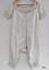 Front view of lady's white, late 19th century combinations. They have short sleeves and are decorated with pintucks and crocheted lace trim.