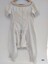 Back view of lady's white, late 19th century combinations. They have short sleeves and are decorated with crocheted lace trim.