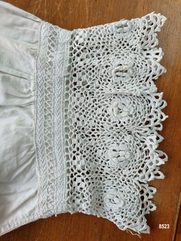The bottom of each leg is decorated with feather stitch and a crocheted lace trim.