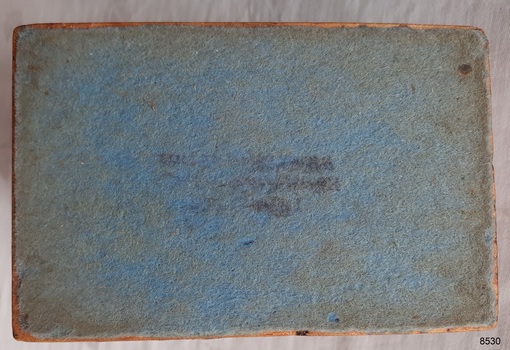 Blue felt base on the box has a purple stamp