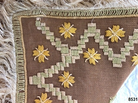 Front corner view of fringed tablecloth