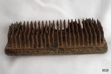 Base is made from layers of metal with rows of spikes inserted into the base