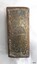 An inscription is stamped into the base