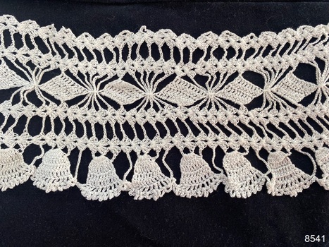 Close view of section of crochet lace to show repeat pattern.