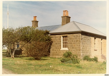 Bluestone building with iron roof , window with 12 panes of glass, steps on right