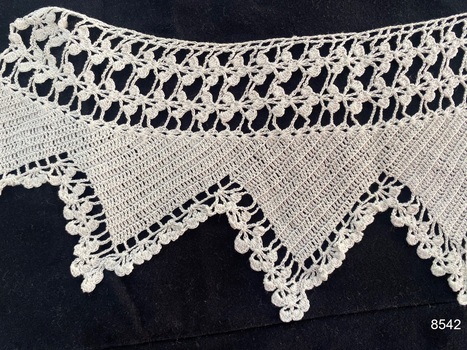 Close view of section of crochet lace to show pattern.