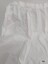 White cotton apron with side pocket featuring a scalloped edge