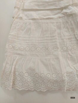 Bottom of petticoat showing two wide and three narrow pintucks and broderie anglaise lace trim