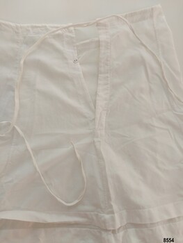 Placket opening on petticoat with button and drawstring ties