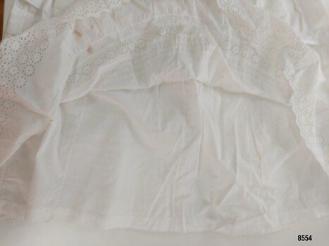 Plain white cotton fabric lining the hem of petticoat