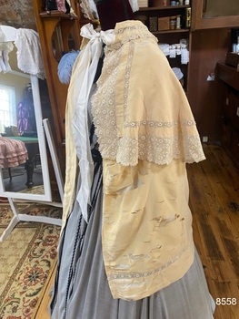 View of left side of double cape with collar.