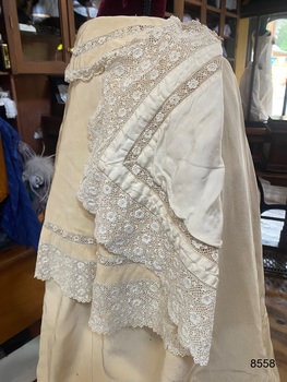 View of the lining and lace edge of the top cape.