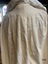 View of pleating across the back of the underneath cape.