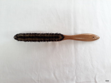 Underneath view of hat brush showing colouring of bristles.