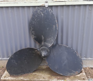 Painted propeller has three blades and pointed cap on the central boss