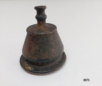Small brass, bell shaped finial topped with a narrow double concave hollow neck
