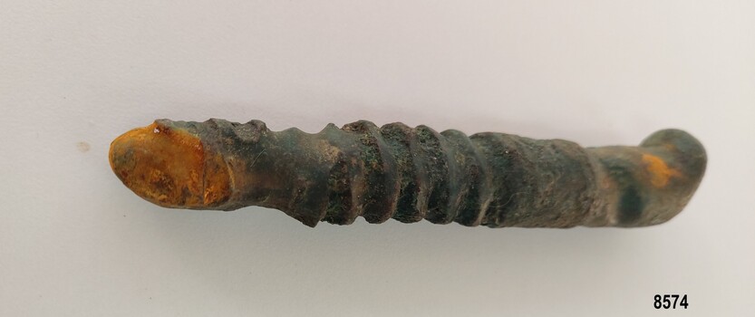 Worn metal bolt showing some rust and damage at end