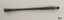 Slender brass rod tapering into the center and widening at each end