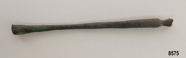 Slender brass rod tapering into the center and widening at each end
