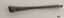 Slender brass rod tapering in the center and widening at each end
