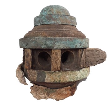 Brass cap over rounded wooden hub, centre reinforced with metal, stub of wheel spoke, two spoke holes