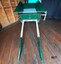 Green wooden dray with green and cream shafts and "No. 3" painted on the front
