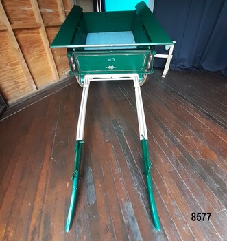 Green wooden dray with green and cream shafts and "No. 3" painted on the front