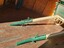 Cream and green wooden shafts with metal hooks and fixtures for attaching the harness 
