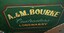 Sign writing on side of dray advertising "A. & M. Bourke, Contractors, Langwarry" in cream on a green background