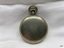 Back view of silver toned fob watch.