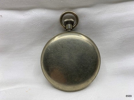 Back view of silver toned fob watch.
