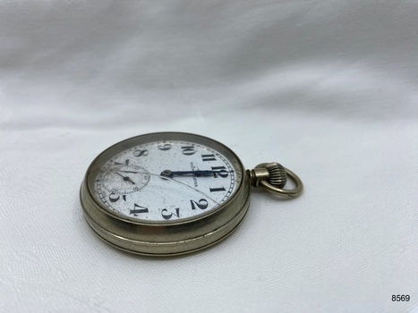 Side view of silver toned fob watch. 