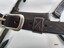 Stitching detail showing design of an elongated X and 4 dots on strap holder