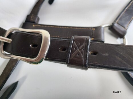 Stitching detail showing design of an elongated X and 4 dots on strap holder