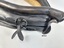 Close up view of two adjustable straps located near top opening of collar