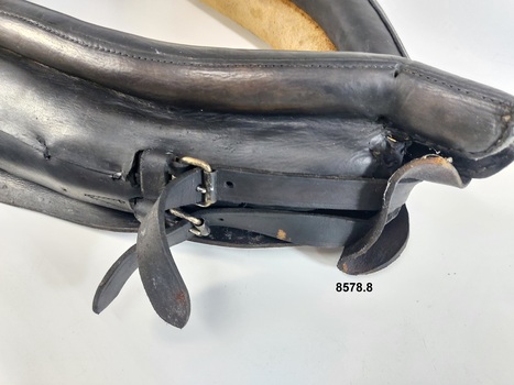 Close up view of two adjustable straps located near top opening of collar