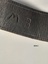The initials M B stamped onto the leather of the horse bridle