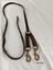 Leather harness strap with two shorter straps (each with a metal clip) attached at one end to a metal D ring