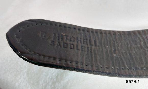 End of strap with maker's stamp reading "R. Mitchell Saddler" and stitching
