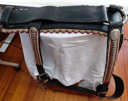 Side view of Breeching Straps which are part of a show harness for a Clydesdale showing some of the decorative leather work and metal ornamentation